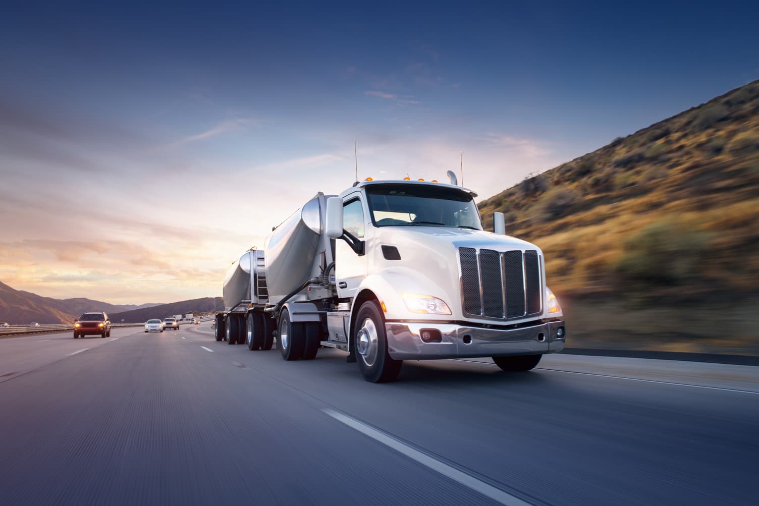 American style truck on freeway pulling load. Transportation theme. Road cars theme.